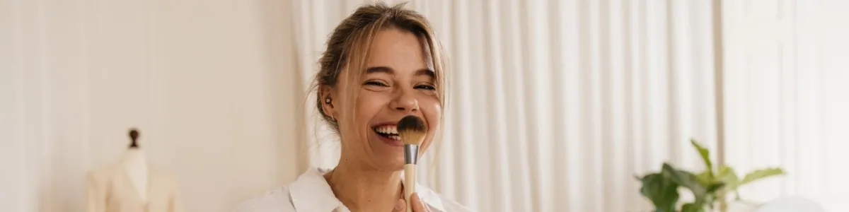 woman smiling with face cream on